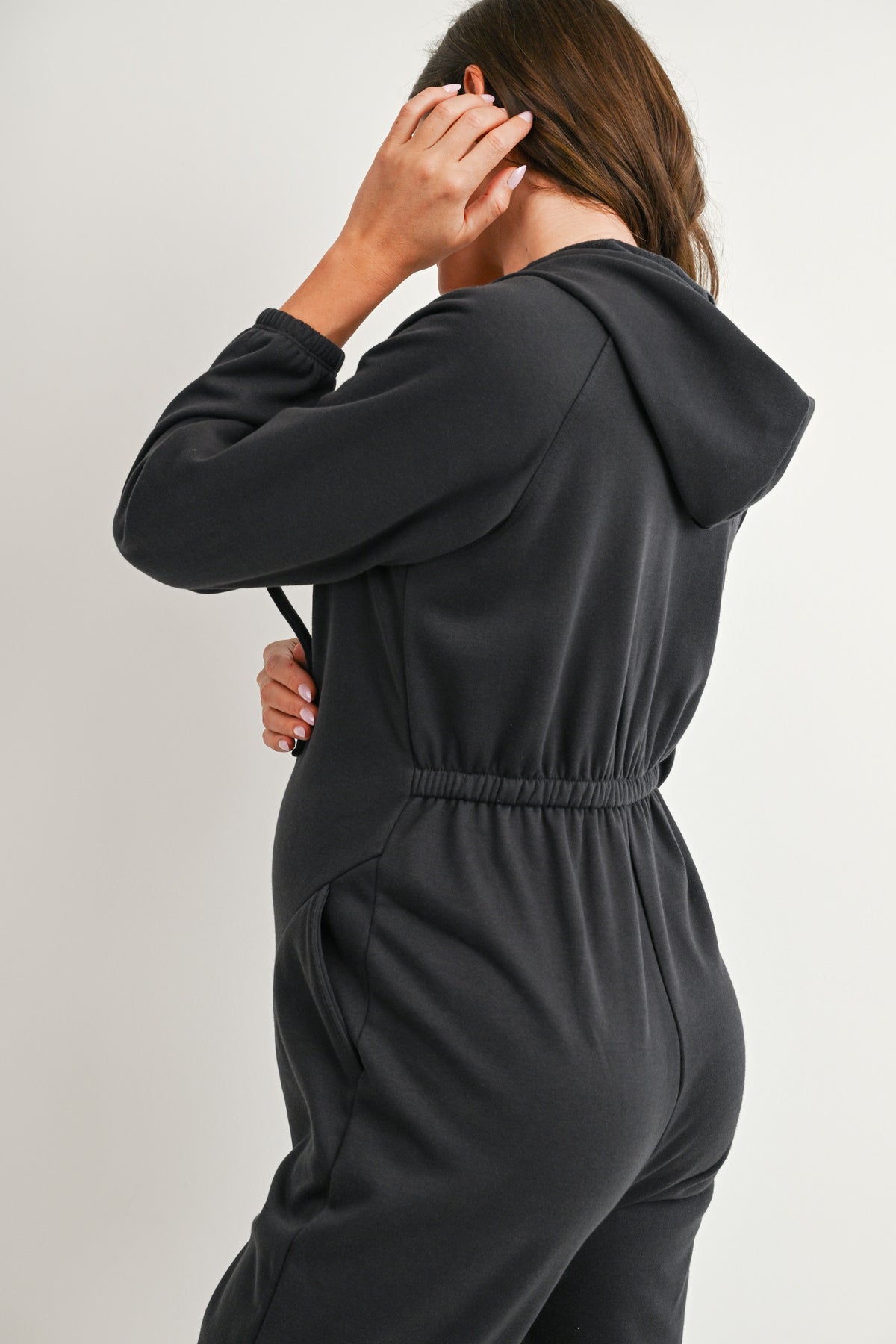 Back detail of charcoal maternity hooded jumpsuit with elasticized waist