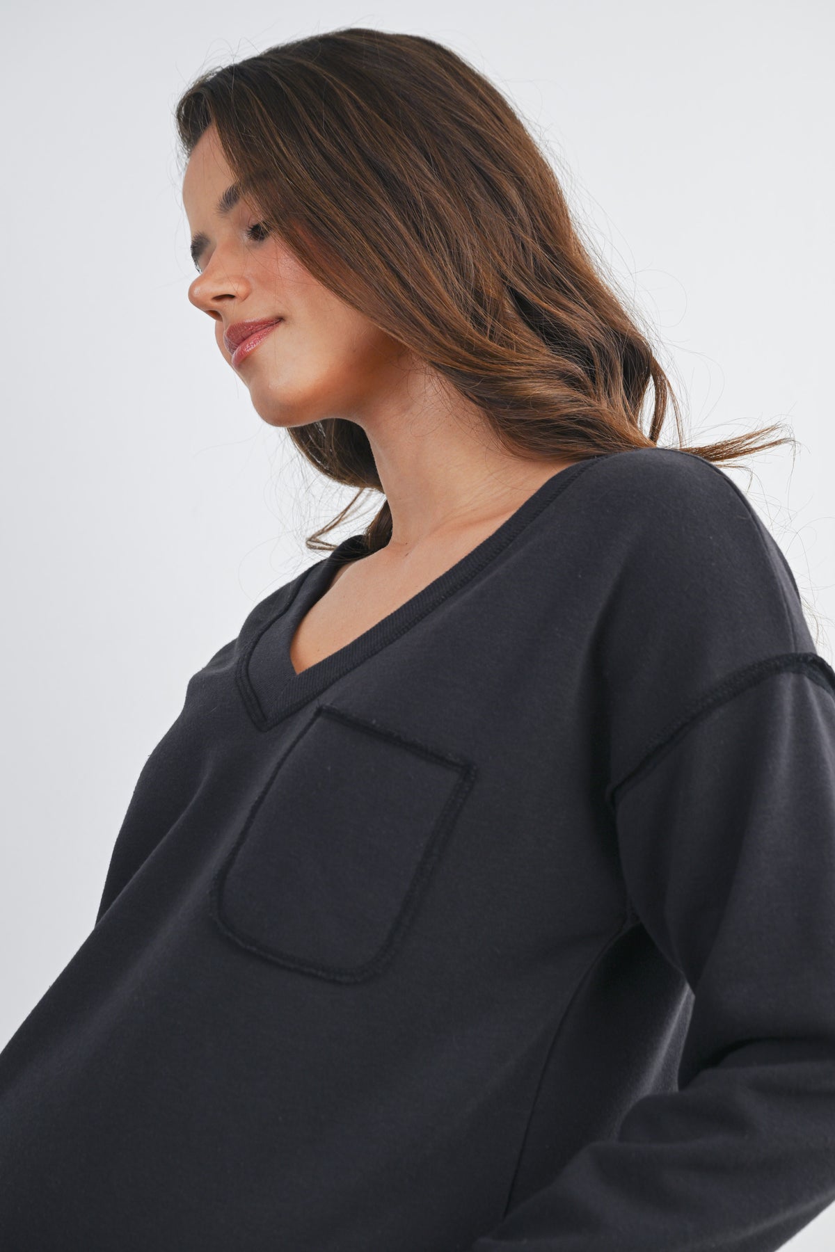 Black V Neck Long Sleeve Front Pocket Maternity Pullover Top Front View Pocket Detail