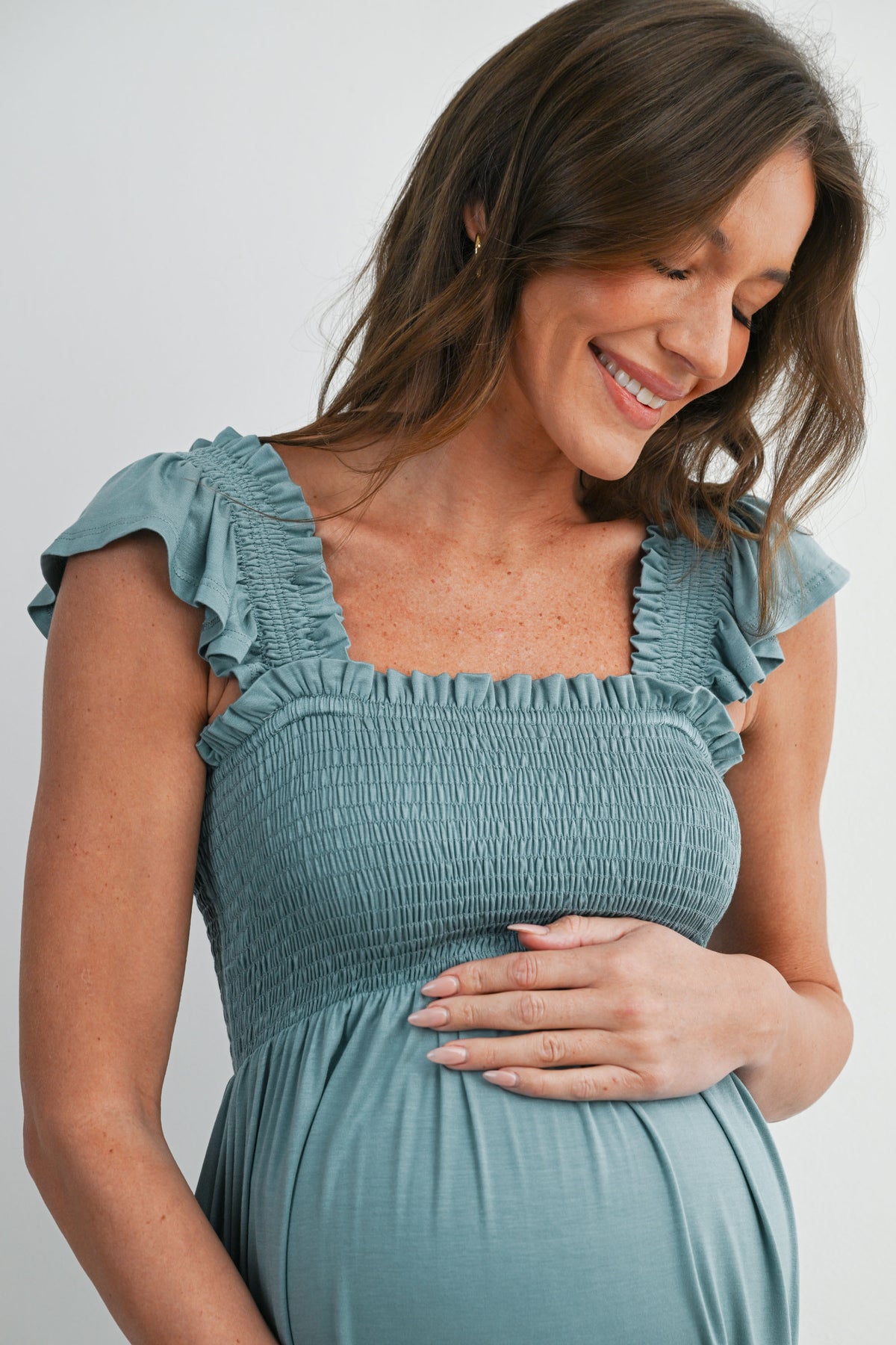 Sage Smocked Empire Waist Maternity Dress with Ruffle Hem Close Up Detail