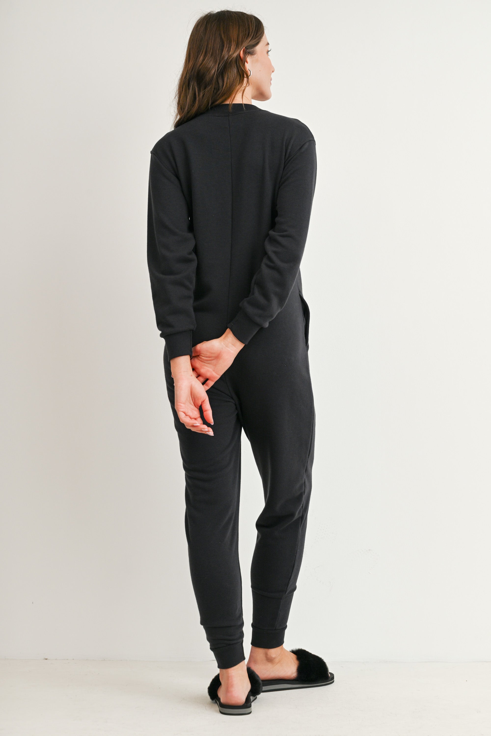 Black maternity nursing jumpsuit with pockets and banded ankle cuffs back view