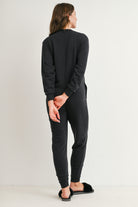 Black maternity nursing jumpsuit with pockets and banded ankle cuffs back view