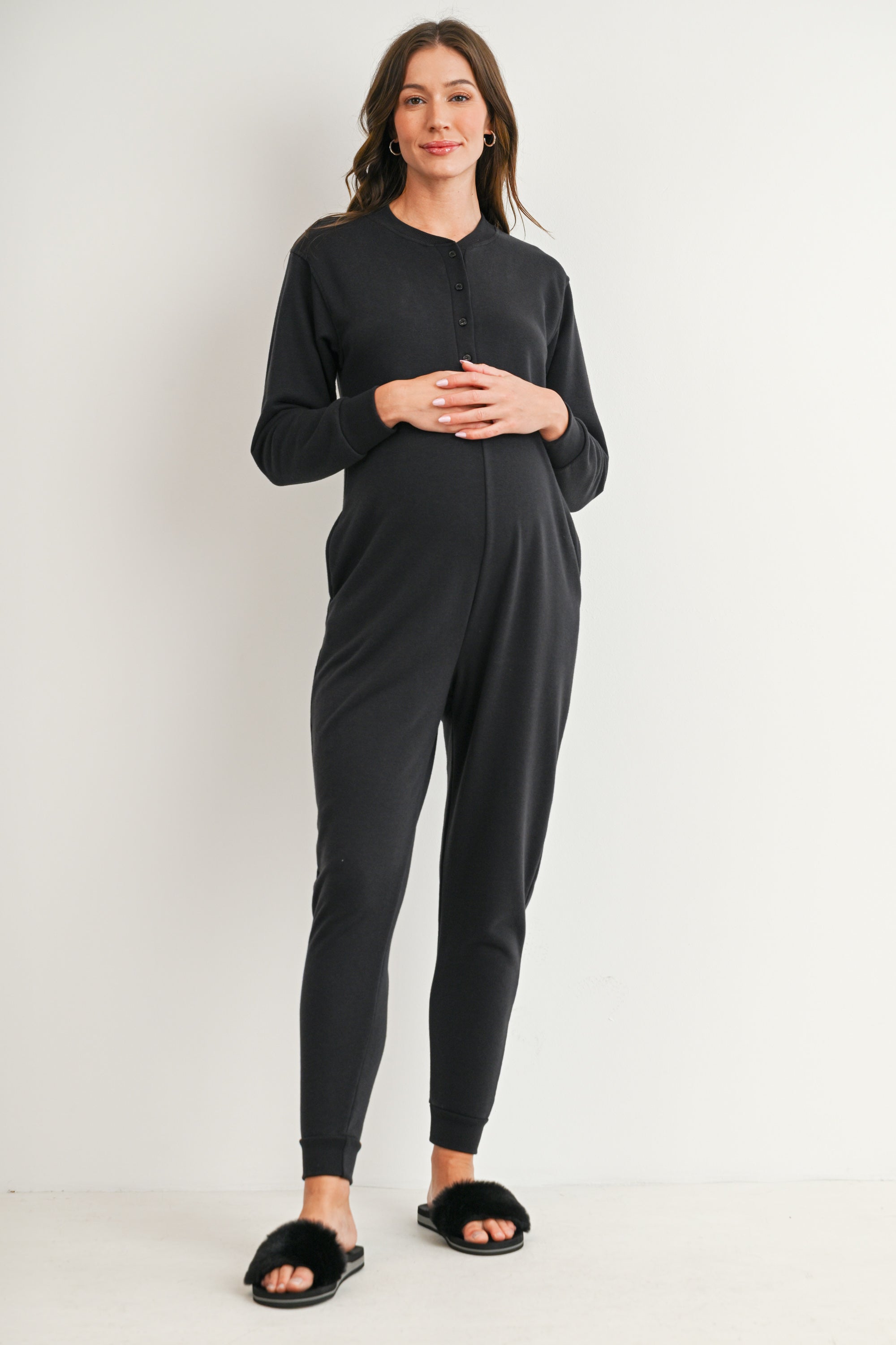 Black maternity nursing jumpsuit with long sleeves and tapered jogger legs
