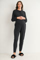 Black maternity nursing jumpsuit with long sleeves and tapered jogger legs