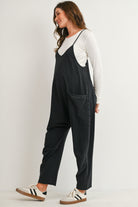 Black maternity overall jumpsuit with pockets and relaxed fit side view