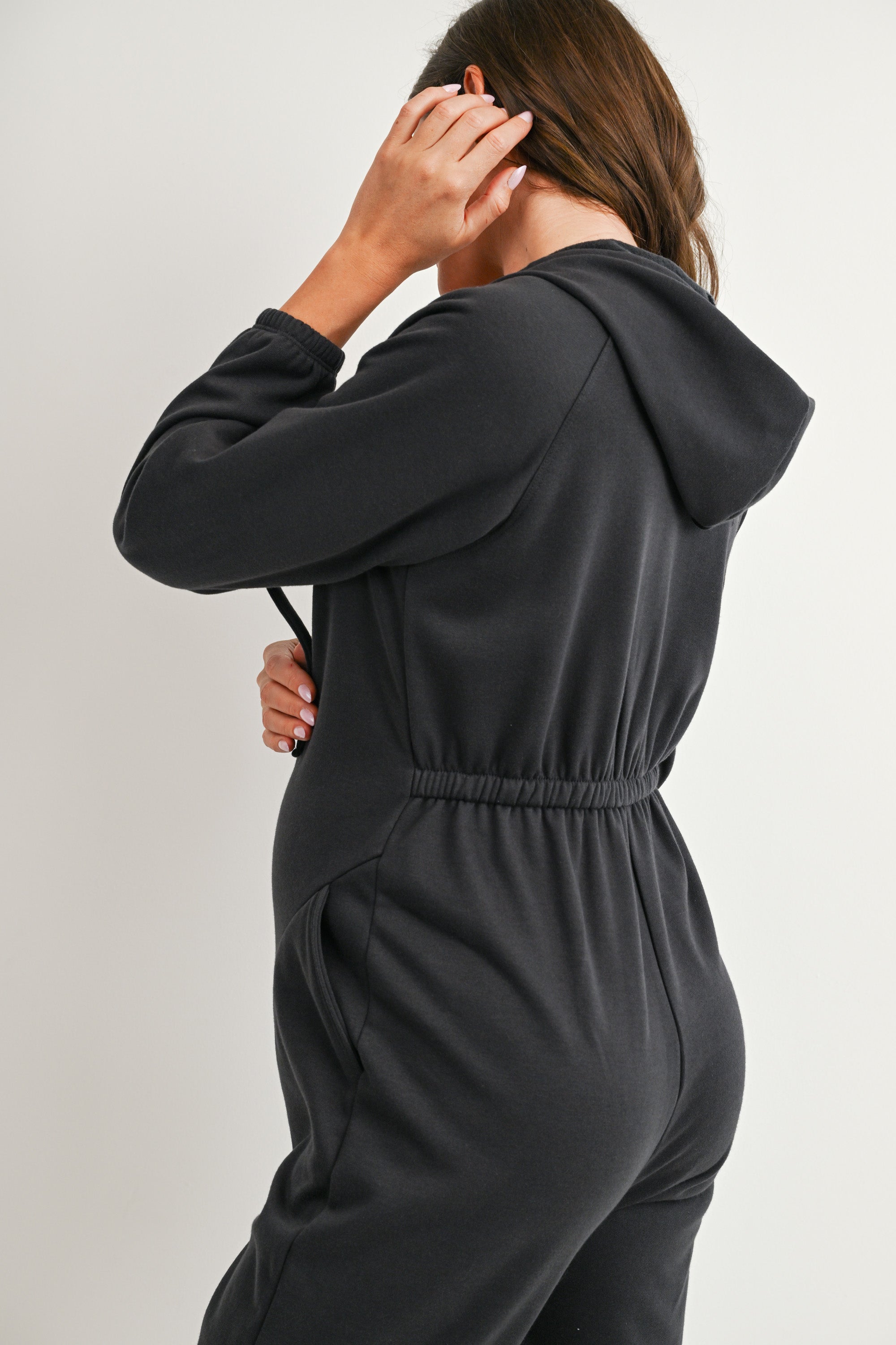 Back detail of charcoal maternity hooded jumpsuit with elasticized waist