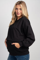 Side view of Black maternity nursing sweatshirt with kangaroo pocket